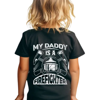 Little girl wearing black tshirt that says my daddy is a firefighter on the back